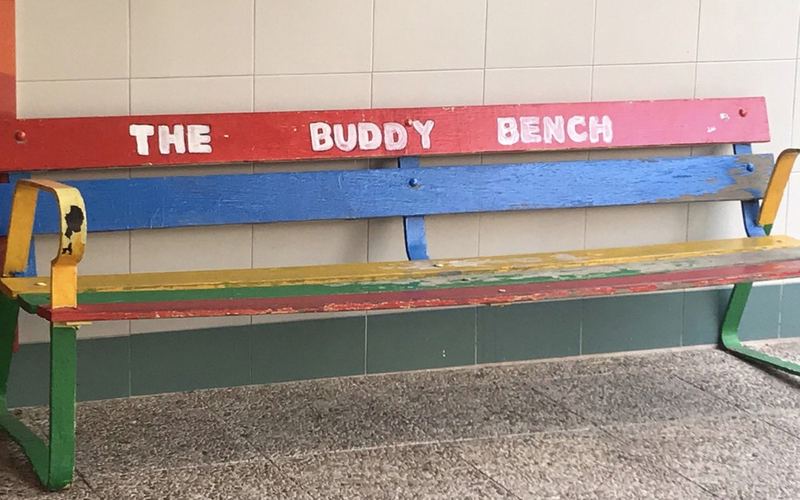 Colourful buddy bench in a school playground in Madrid
